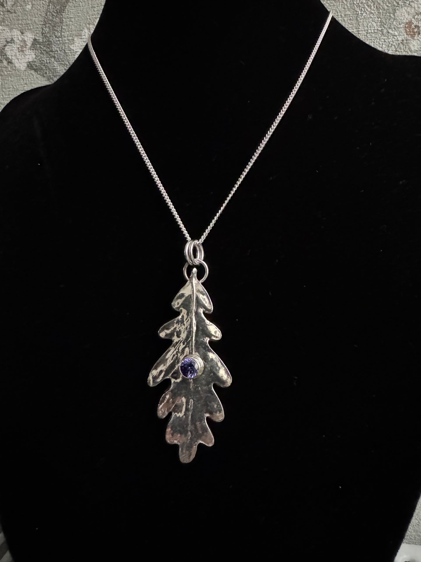 Silver oak leaf with purple CZ gem