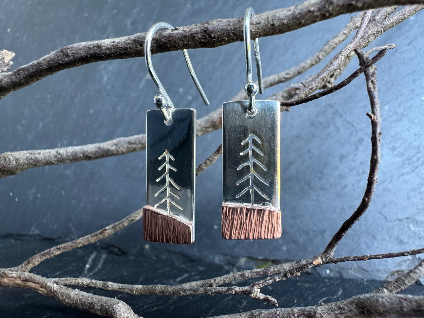 Pair of silver and copper earrings with tree design