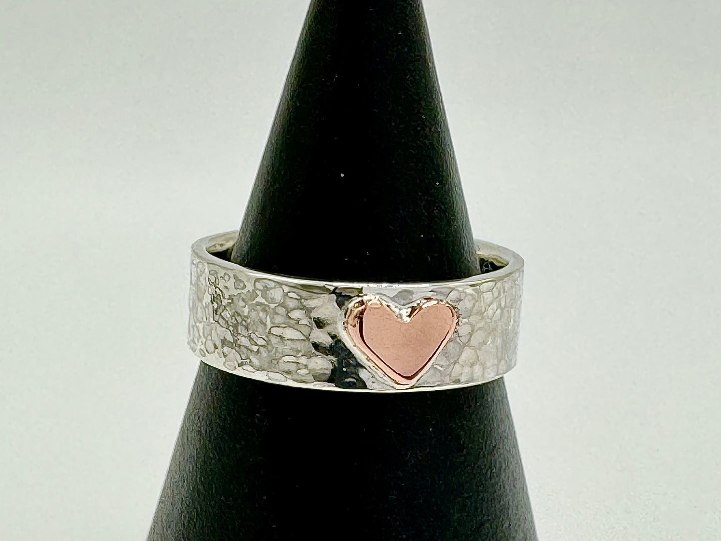Handmade copper heart on silver hammered band