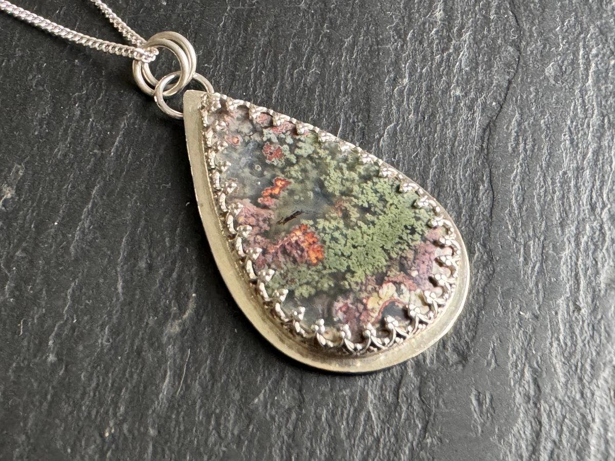 Moss agate in silver setting pendant.