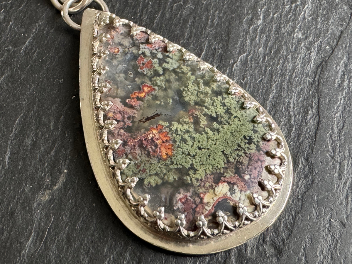 Moss agate in silver setting pendant.
