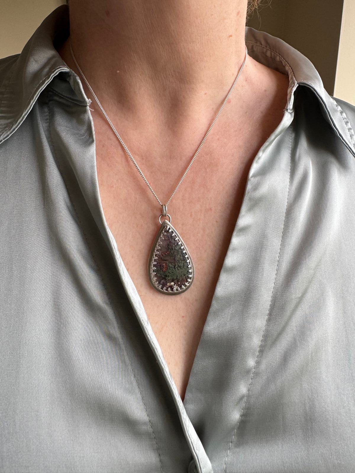 Moss agate in silver setting pendant.