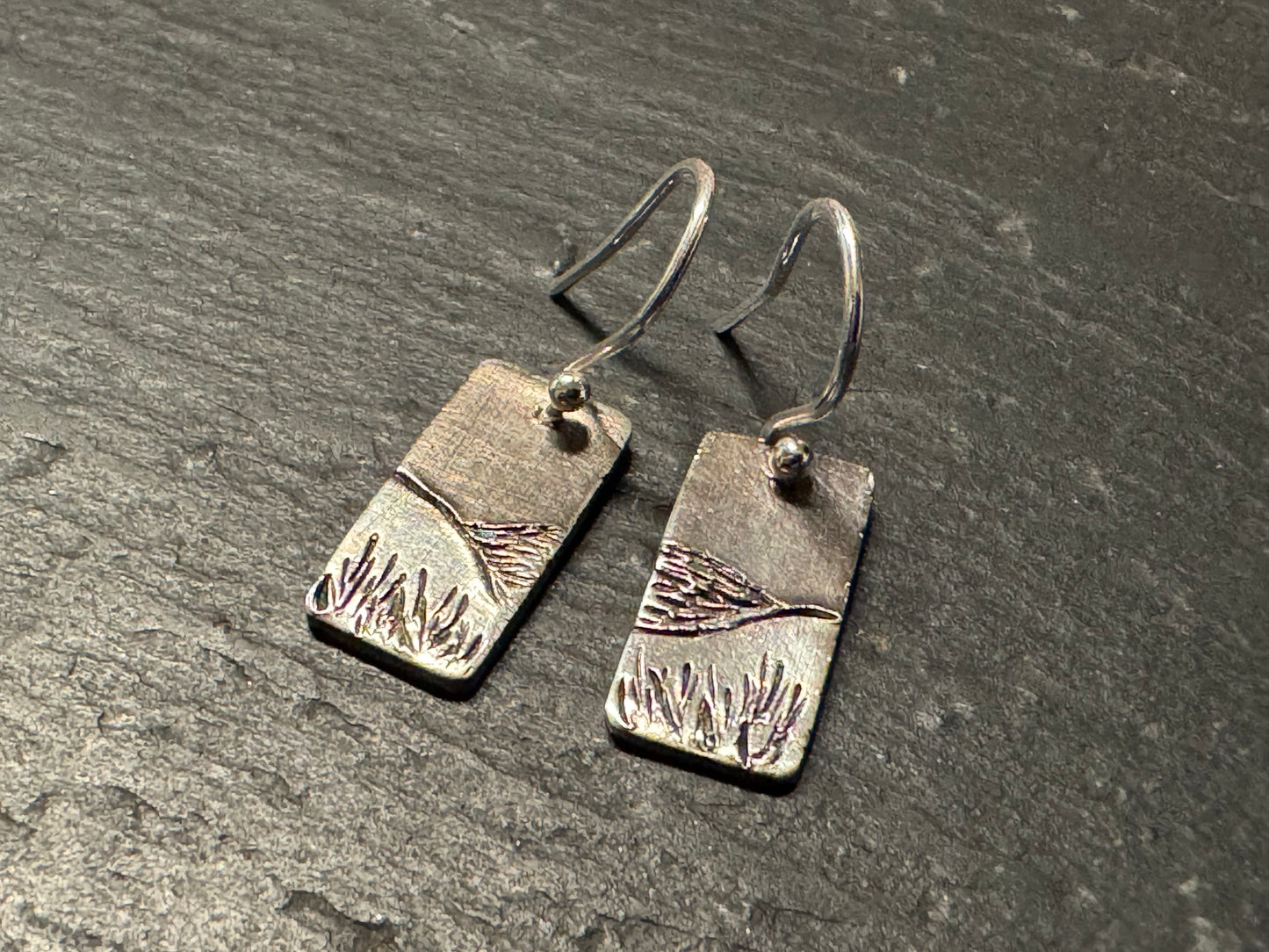 Silver earrings with engraved hill design