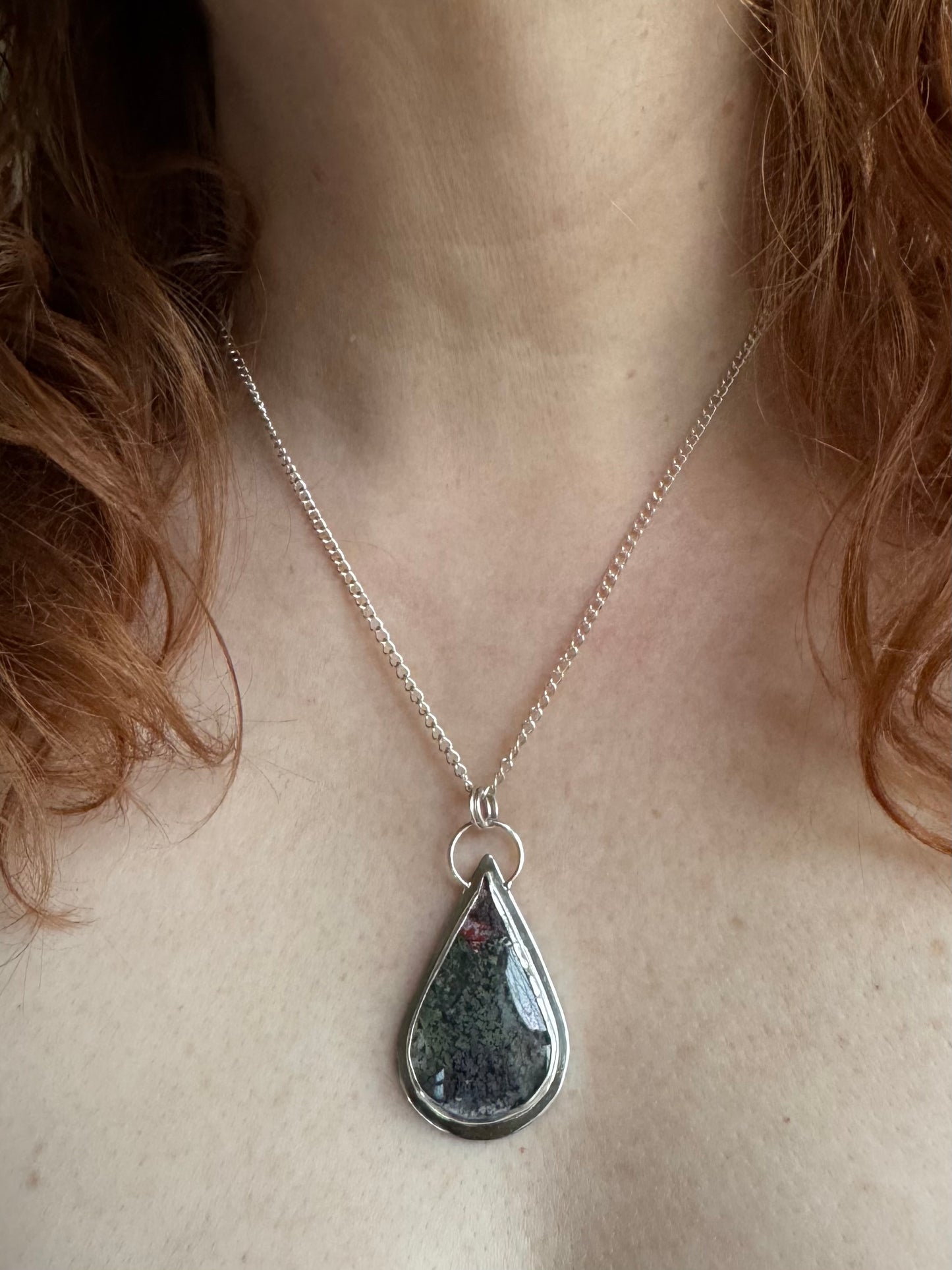 Moss agate in silver setting pendant.