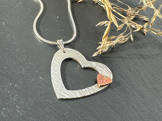 Handmade small copper heart on silver heart outline necklace